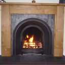 Oak surround black arch black slate hearth